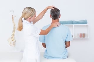Chiropractor gives patient a neck adjustment