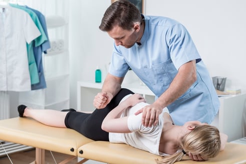 Chiropractor performing an adjustment on a patient