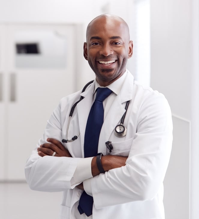 doctor with arms folded smiling