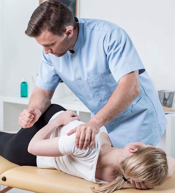 chiropractor adjusting womans back